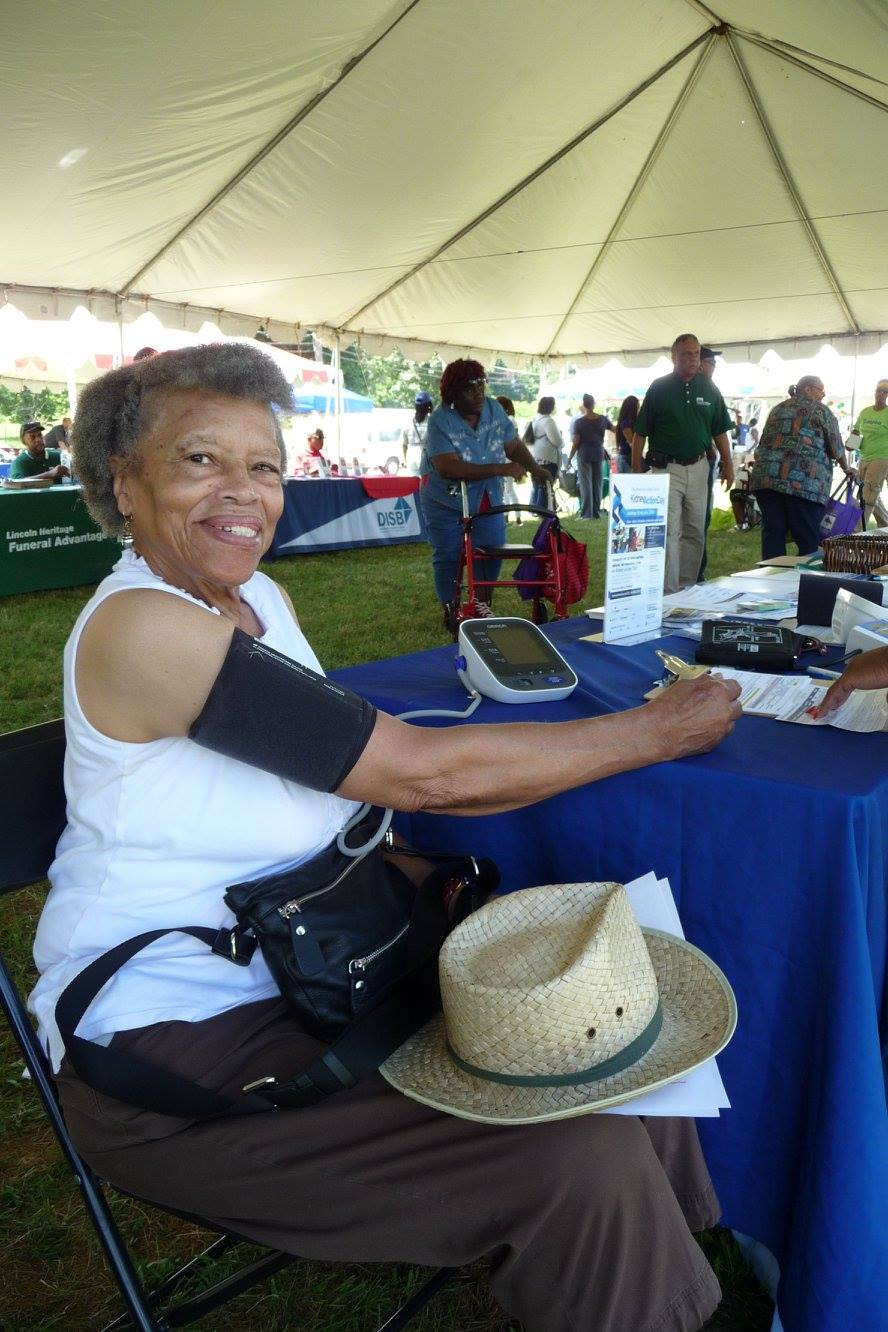 Senior woman checking her blood pressure at an event